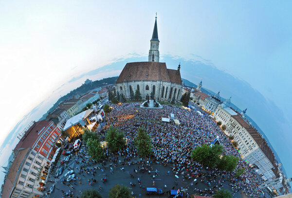 Little planet projection of a crowded square. Cluj Napoca, Romania