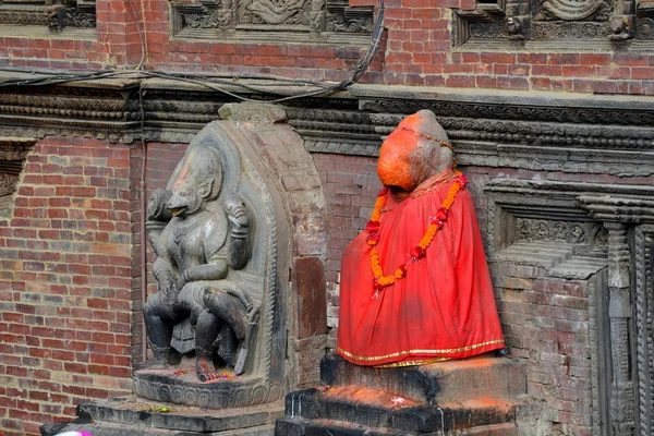 Stone relief, sculpture of Shiva the destroyer painted in red in Patan, Nepal — Stock Photo, Image