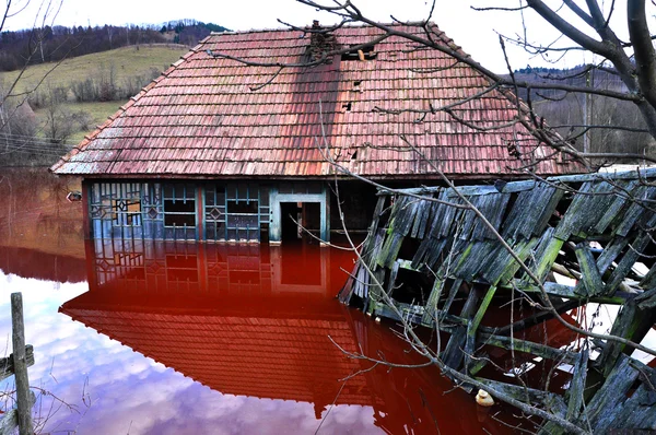 Un desastre ecológico. Una casa inundada de agua contaminada de una mina de cobre a cielo abierto —  Fotos de Stock