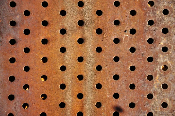 Rusty iron background with holes — Stock Photo, Image