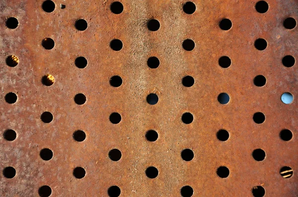 Rusty iron background with holes — Stock Photo, Image