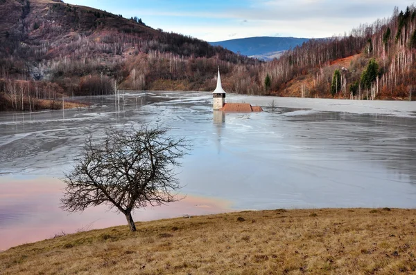 A flooded church in a toxic red lake. Water polluting by a coppe — Stock Photo, Image