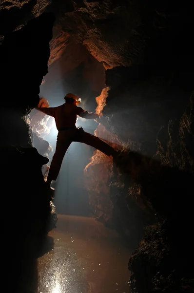 Silhouette of a cave explorer in the underground — Stock Photo, Image