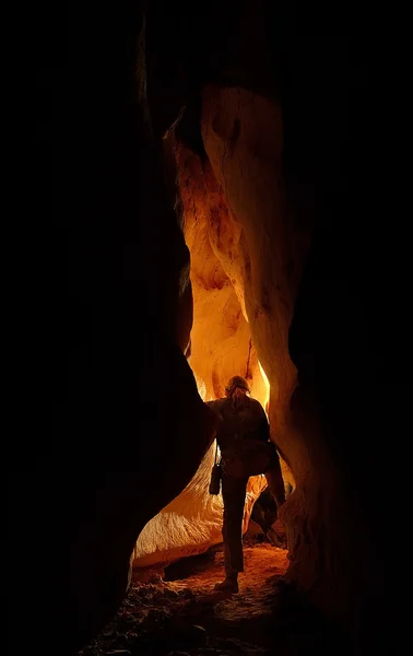 Underground cave passage with a caver — Stock Photo, Image