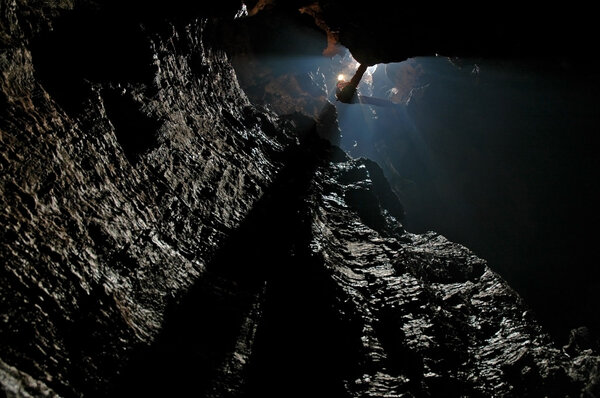 Caver abseiling in a pothole 