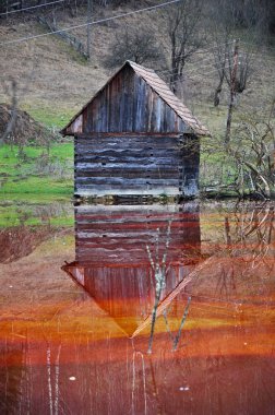 Abandoned house flooded in a lake clipart