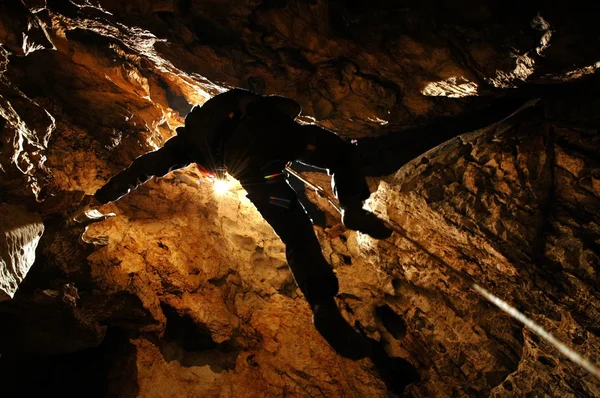 Spelunker abseilen in een kuil — Stockfoto