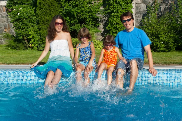 Family having fun near swimming pool — Stock Photo, Image