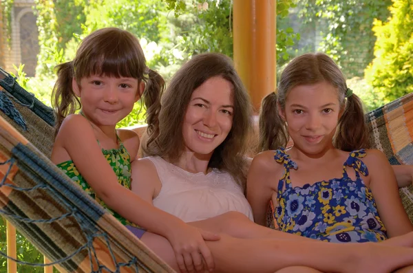 Happy mother and children having fun in hammock — Stock Photo, Image