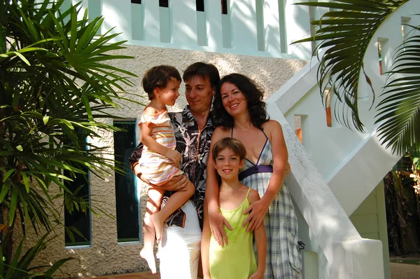 Happy family of four near house — Stock Photo, Image