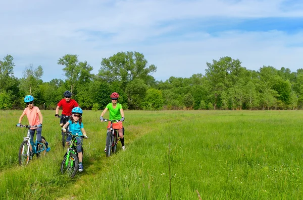 Happy family on bikes, cycling outdoors — Zdjęcie stockowe