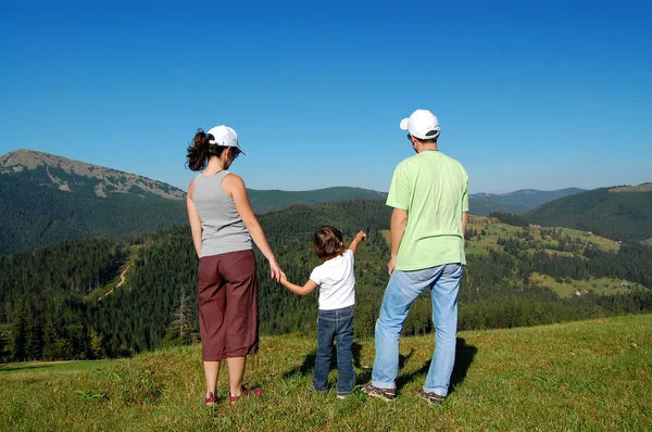 Family with child hiking in mountains — Stock Photo, Image