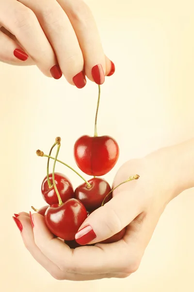 Hands cherry with red nails manicure — Stock Photo, Image