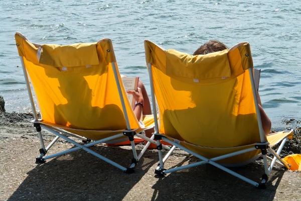 Rear view of women on a beach chairs — Stock Photo, Image