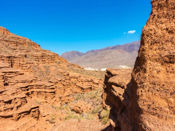 Red rocks and a passage between rocks. Clay canyons. Issyk-Kul region in Kyrgyzstan.