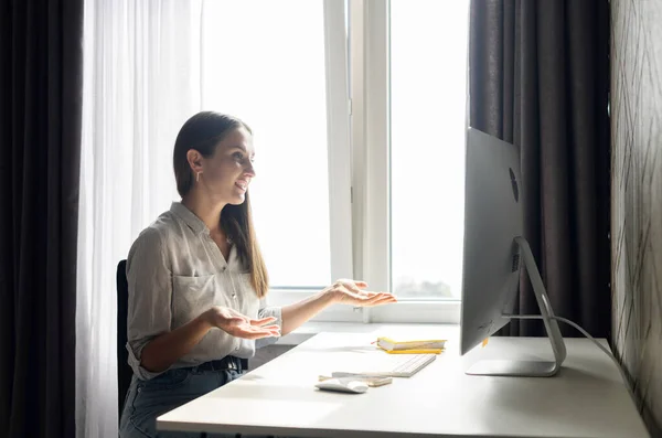 Freelancer woman has video meeting working remotely from home