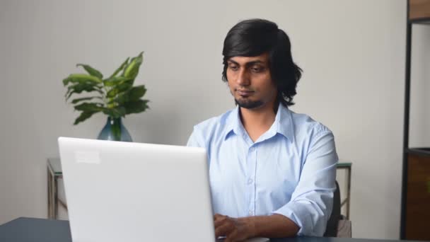 Tired and bored indian male office employee staring at the laptop screen — ストック動画