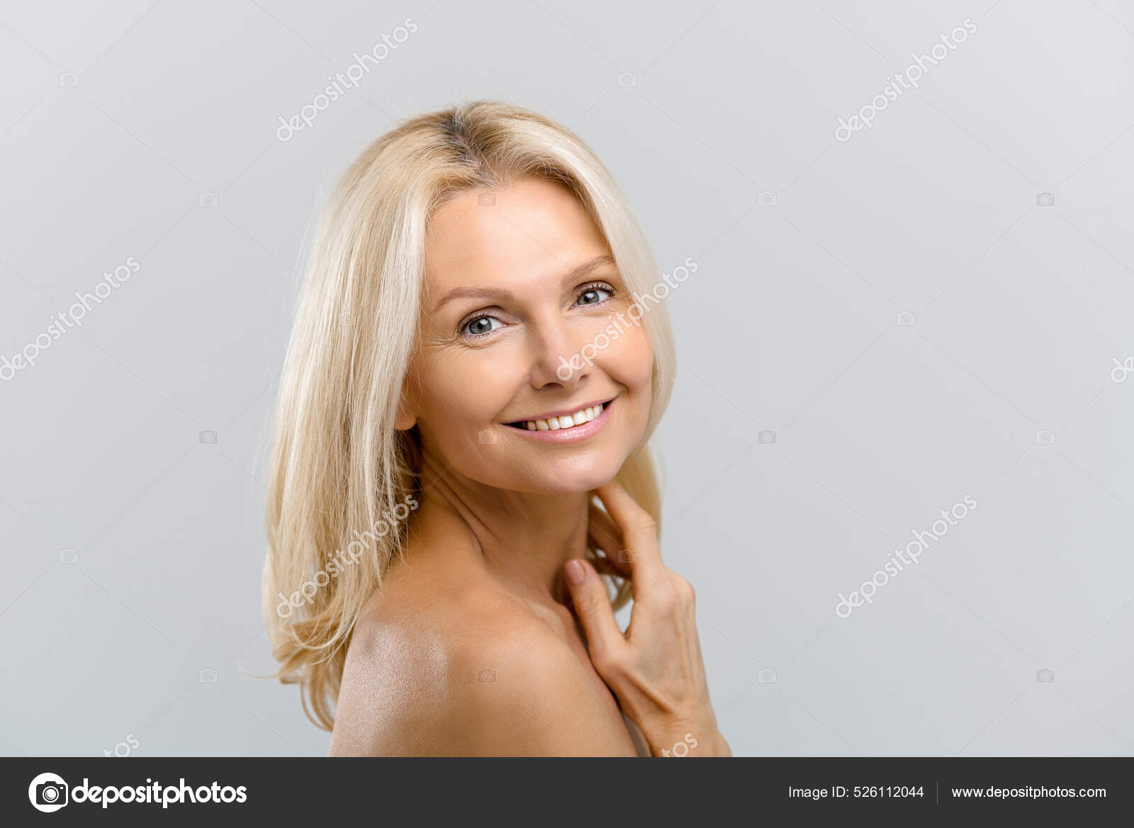 Stunning middle-aged woman with naked shoulders looks at camera — Stock Photo © VadymPastukh