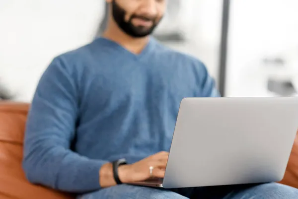 Cropped picture of Indian man using laptop, Hispanic guy is typing on the keyboard — Stock Photo, Image