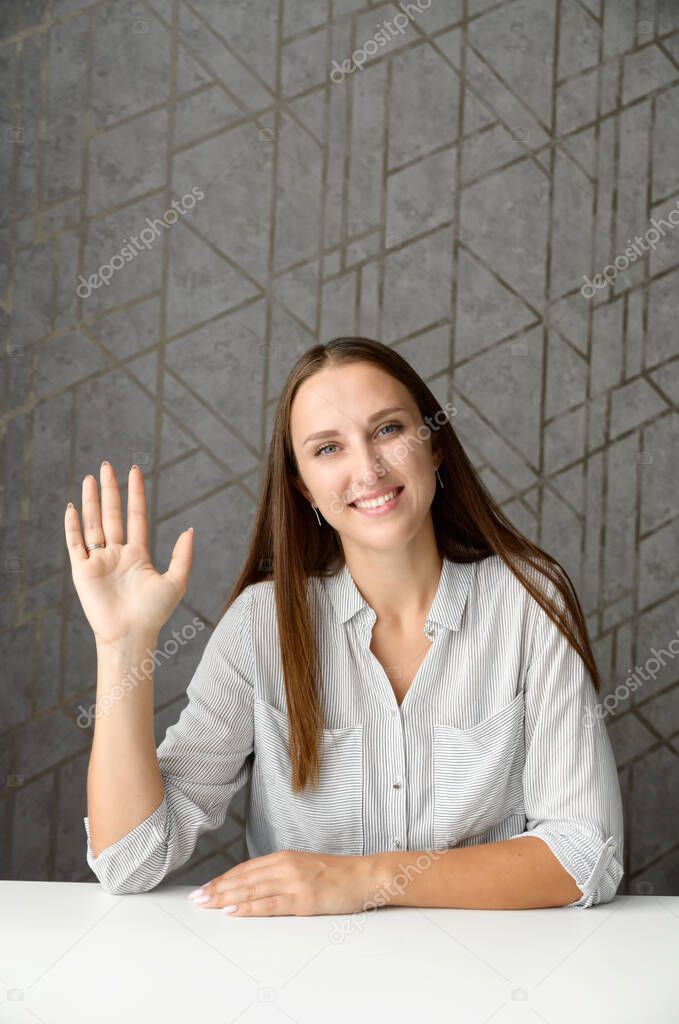 Cheerful happy young woman takes a part in video meeting