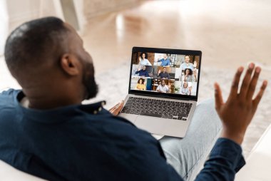 Çeşitli meslektaşlarla sabah toplantısı. Bilgisayar uygulaması kullanan Afro-Amerikalı adam.