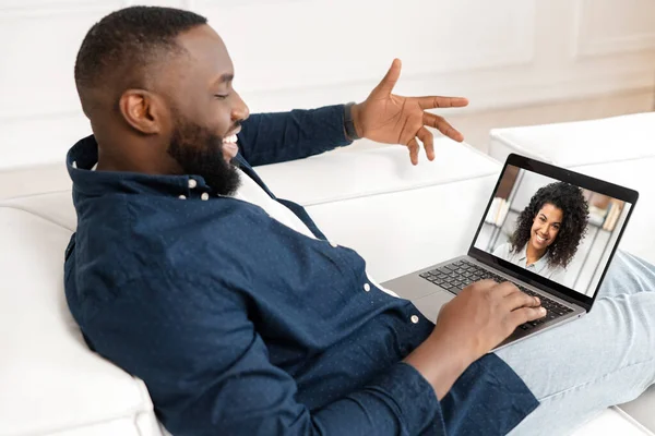 Glücklich afroamerikanisch guy making video call to charming biracial woman — Stockfoto