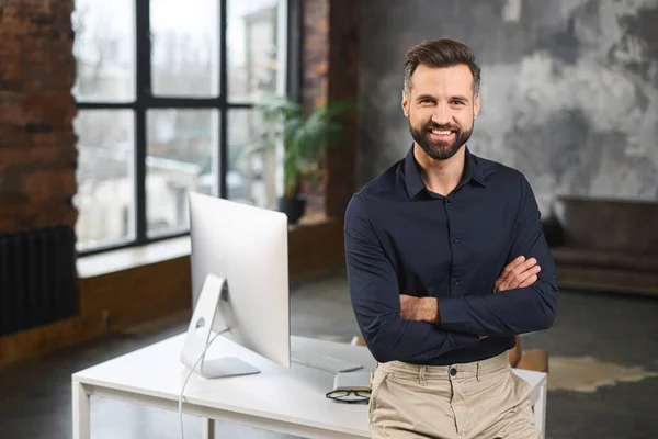 Proud and successful young businessman in smart casual wear with arms crossed — Stock Photo, Image