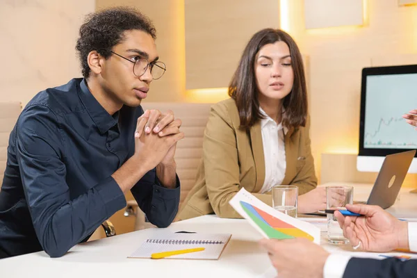 Going over details. Group of young confident business people discussing something while spending time in the office. Male office worker looking at colleagues while discussing — Stock Photo, Image