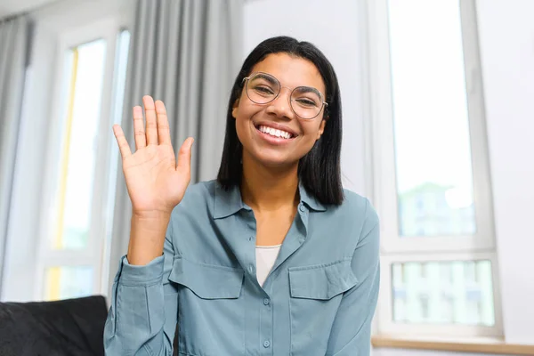 Multiracial brunette female having video call, while spending time at home and waving at the camera, saying hello. Job hunting — 스톡 사진