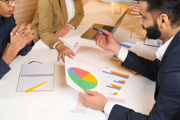 Group of young business people working together in big coworking office. Marketing department discussing product plan. Brunette woman showing something to colleagues. New startup company — Fotografia de Stock