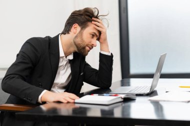 Frustrated male office employee in suit received fired or bankruptcy notification