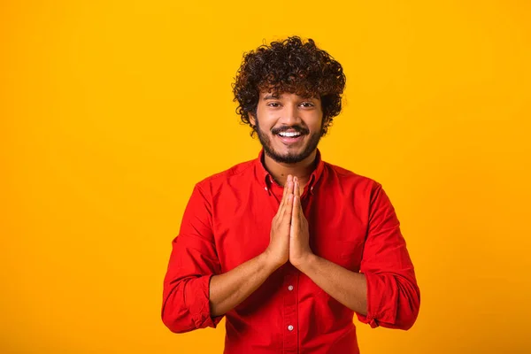 Νεαρός γενειοφόρος άνδρας διπλώνει τα χέρια στην προσευχή, κλείνει τα μάτια και μιλάει στο Θεό, ζητάει βοήθεια, εκφράζει ευγνωμοσύνη. Φωτογραφία εσωτερικού χώρου — Φωτογραφία Αρχείου