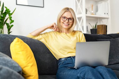 Beyaz, son sınıf öğrencisi bir kadın boş zamanlarını dizüstü bilgisayarla geçiriyor. Rahat koltukta oturan ve kameraya bakan sakin bir kadın. Web gezmesi, TV dizisi izlemek
