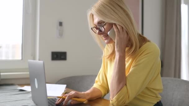 Portré egy bájos érett középkorú szőke nő szemüvegben egy okostelefon — Stock videók