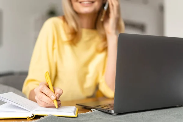 Cropped view of the senior bossy businesswoman having phone conversation working with a laptop at the desk in office. Aged saleswoman talking with a customers — Photo