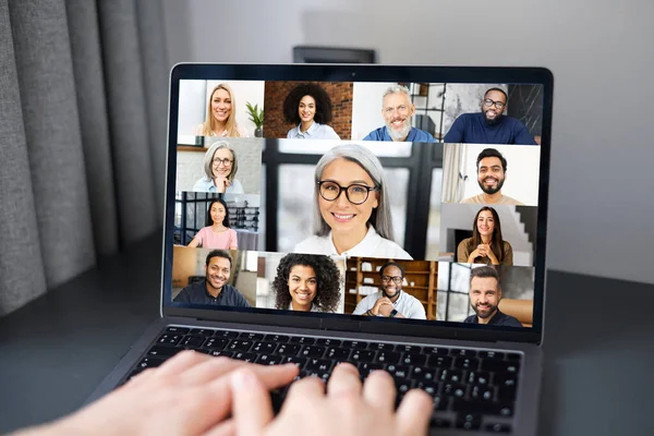 Video chat with employees. Cropped view of the caucasian guy having online meeting with many people together — Zdjęcie stockowe