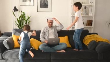 Crazy irritated father screaming with eyes closed, closing ears with palms