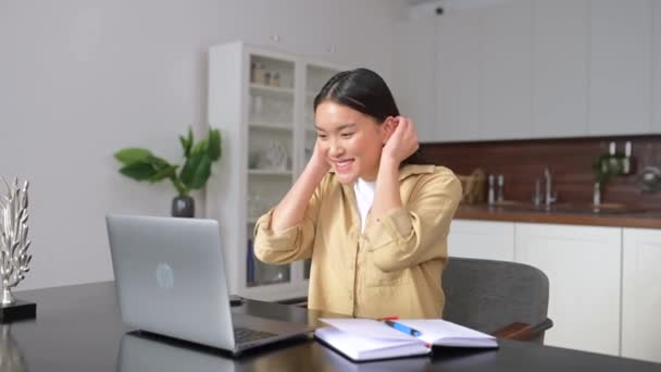 Happy asian female student making video call to distant friends — Stock video
