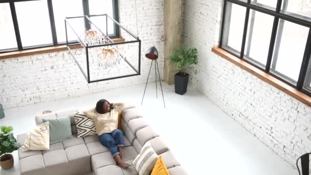 High angle view of the charming modern woman resting sitting on comfortable couch — Stock video