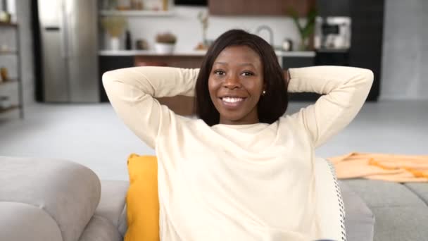 African-American woman rest at home, serene ethnic female sitting on the comfortable couch — Stockvideo