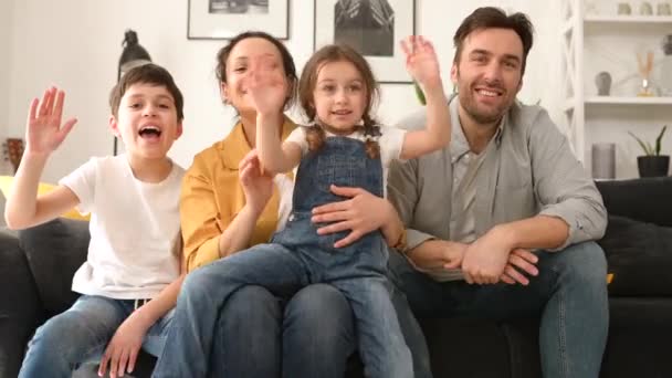 Video connection with cheerful family of four — Stockvideo