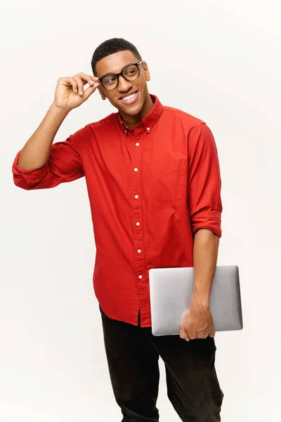 Vertical shot of optimistic handsome African-American male entrepreneur in casual red shirt — Stock fotografie