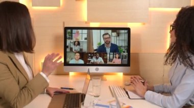 Intelligent clever female and male office employees making video call