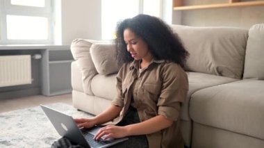 Smiling multiracial woman using laptop