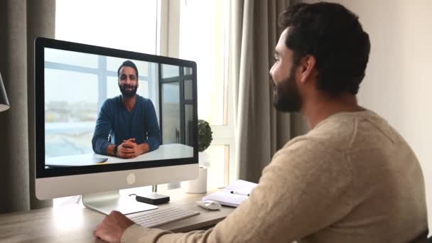 Indian dark-haired man using computer for video call — Video Stock