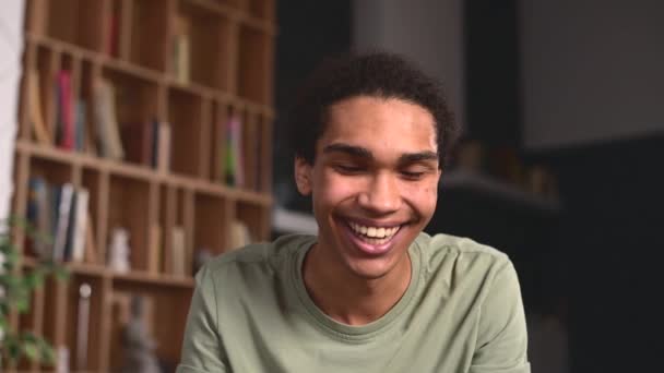 Headshot of a cheerful multiracial guy at virtual meeting — Vídeos de Stock