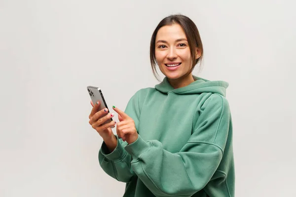 Friendly lady making video call on mobile phone or broadcasting stream, using gadget for online communication — Foto de Stock