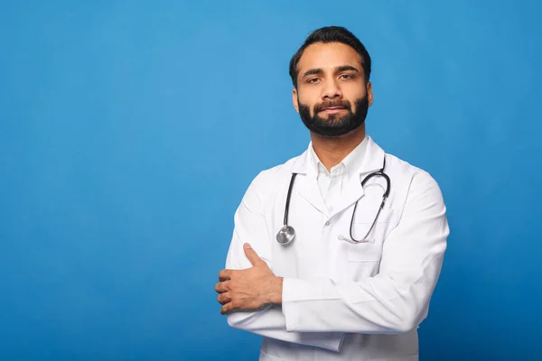 Serious Indian male doctor pediatric, physical, therapist wearing white medical gown with stethoscope — Stock fotografie