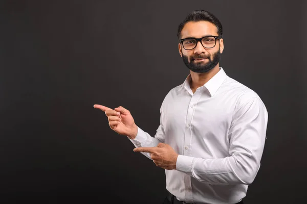 Confident serious businessman wearing official style clothes pointing finger away and paying your attention at empty space — Fotografia de Stock