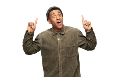 Yüzünde mutlu bir ifade olan çekici bir adam iki parmağıyla işaret ederek, fotokopi alanını sunuyor. Beyaz arka planda izole edilmiş kapalı stüdyo görüntüleri